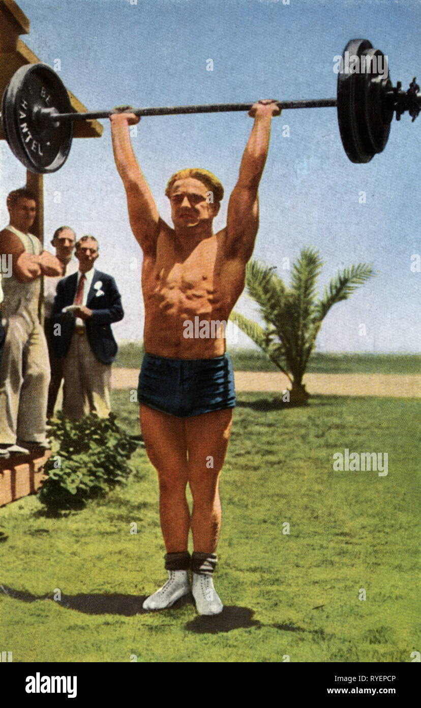 sports, Olympic Games, Los Angeles, 1932, X Summer Olympics, 30.7. - 14.8.1932, heavy athletics, men, weightlifting, middleweight winner Rudolf Ismayr (Germany) at training, cigarette card, scrapbook 'Die Olympischen Spiele 1932', Reemstma Cigarettenfabriken GmbH, Germany, 1932, Additional-Rights-Clearance-Info-Not-Available Stock Photo