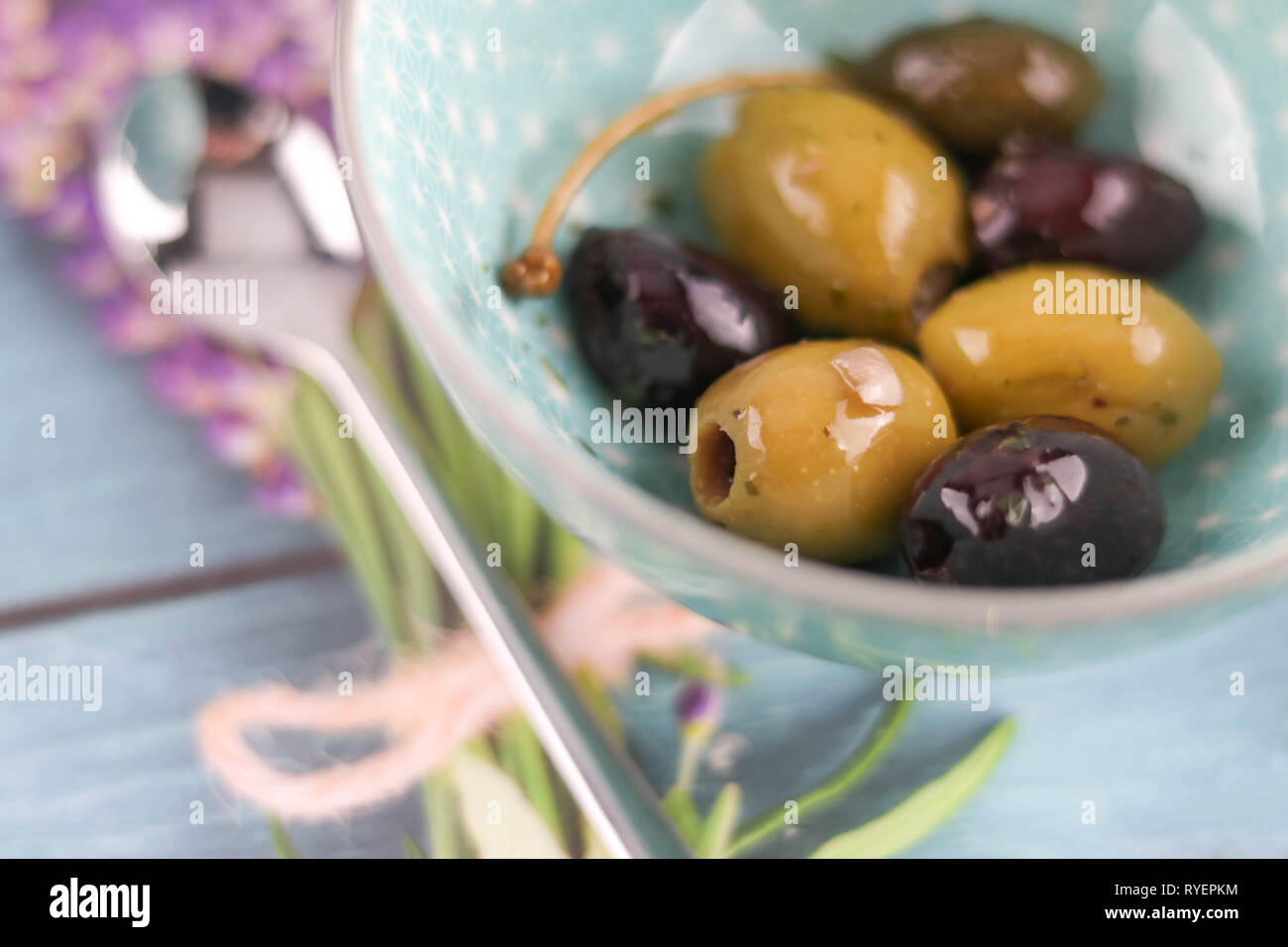 mixed olives on decorated table with copy space Stock Photo