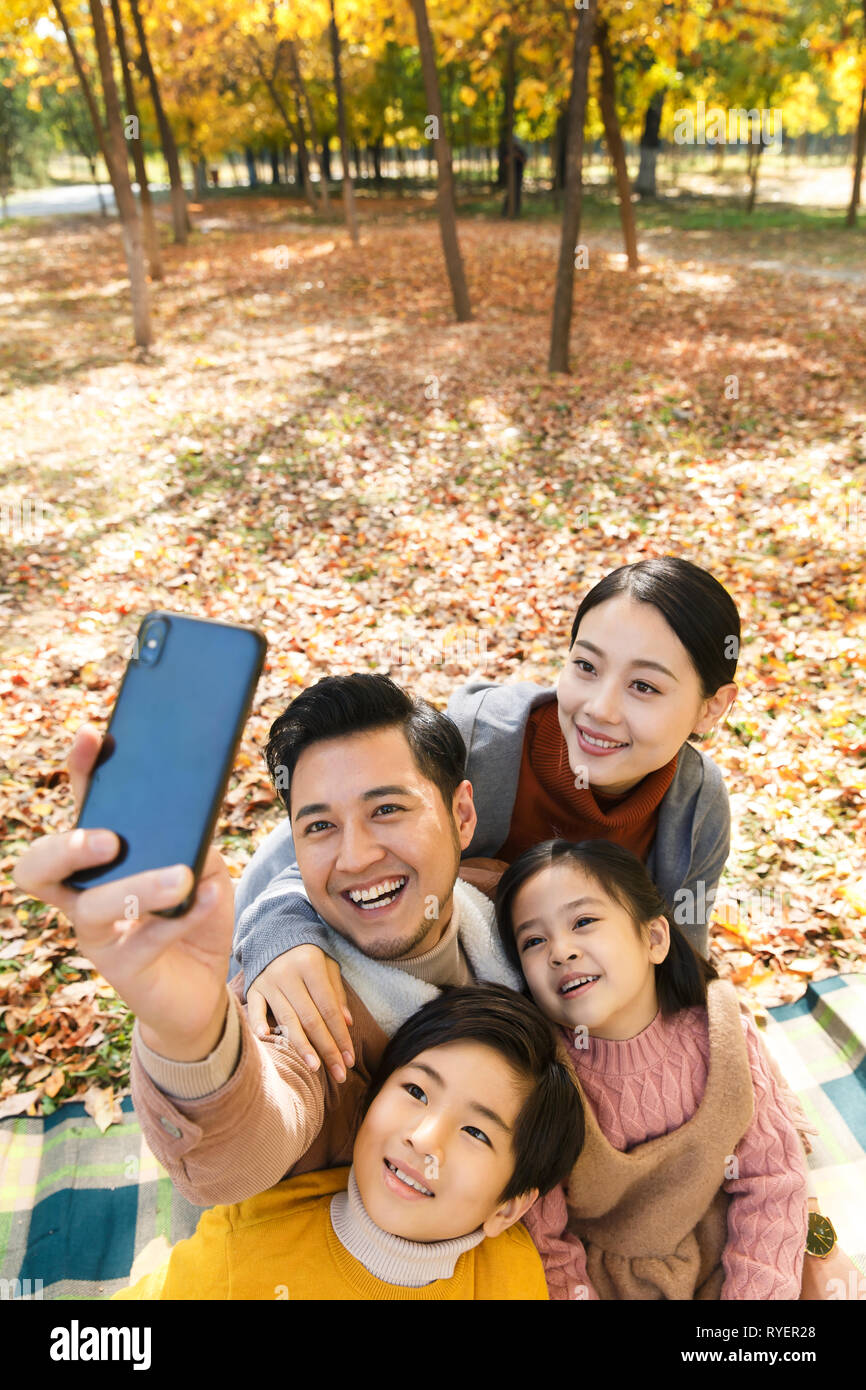 Happy family in the outdoor taking pictures Stock Photo - Alamy