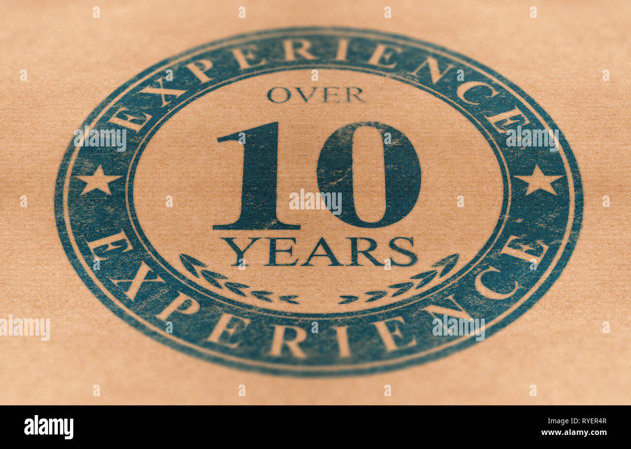 Composite Image between a stamp drawing and a brown paper photography. Rubber stamp label of a company over 10 years of experience. Stock Photo