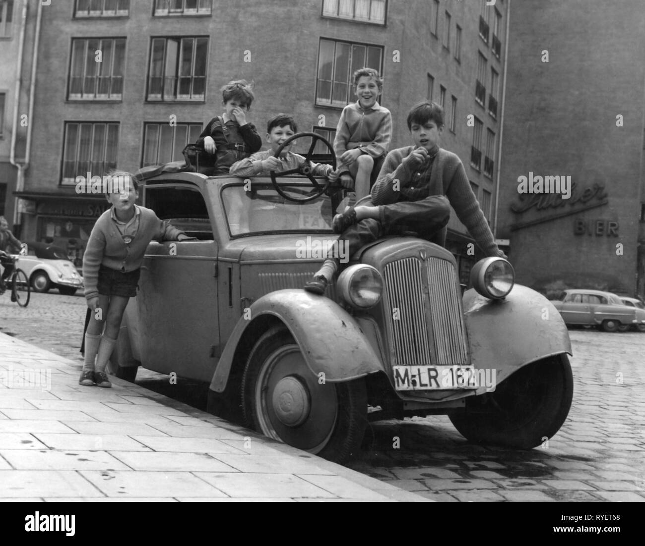 people, children, playing, boys with old DKW car, Munich, circa 1950, Germany, childhood, infancy, half-length, half length, standing, sitting, sit, a ripple of laughter, laugh, laughing, fun, cap, caps, steering wheels, adjustable steering wheel, car, cars, DKW F8, street, streets, 20th century, 1950s, children, child, kids, kid, playing, play, boys, boy, historic, historical, boy, boys, male, people, 1940s, Additional-Rights-Clearance-Info-Not-Available Stock Photo