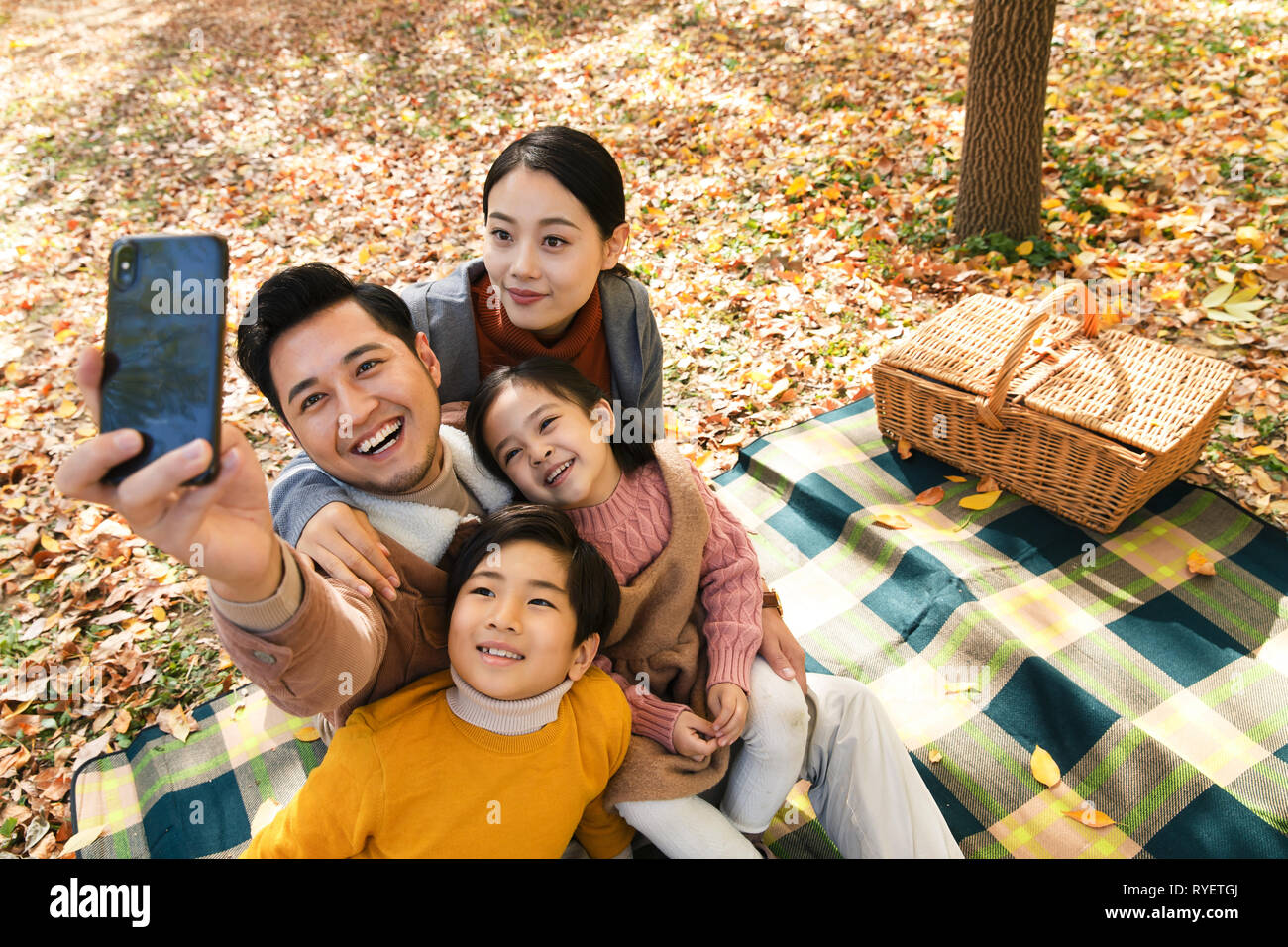 Happy family in the outdoor taking pictures Stock Photo - Alamy