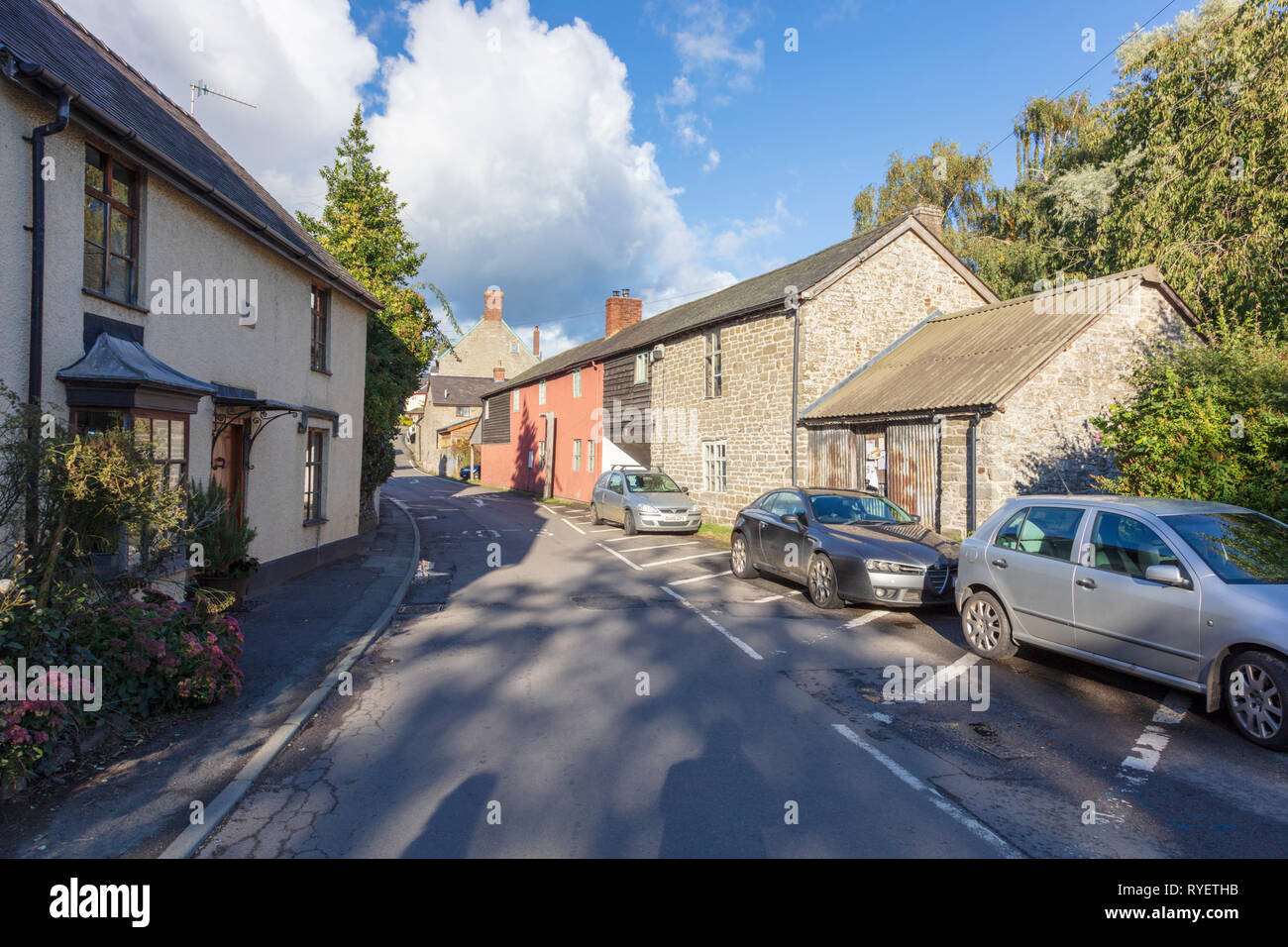 Narrow street with cottages and converted barn in the pretty village of Clun, Shropshire, UK Stock Photo