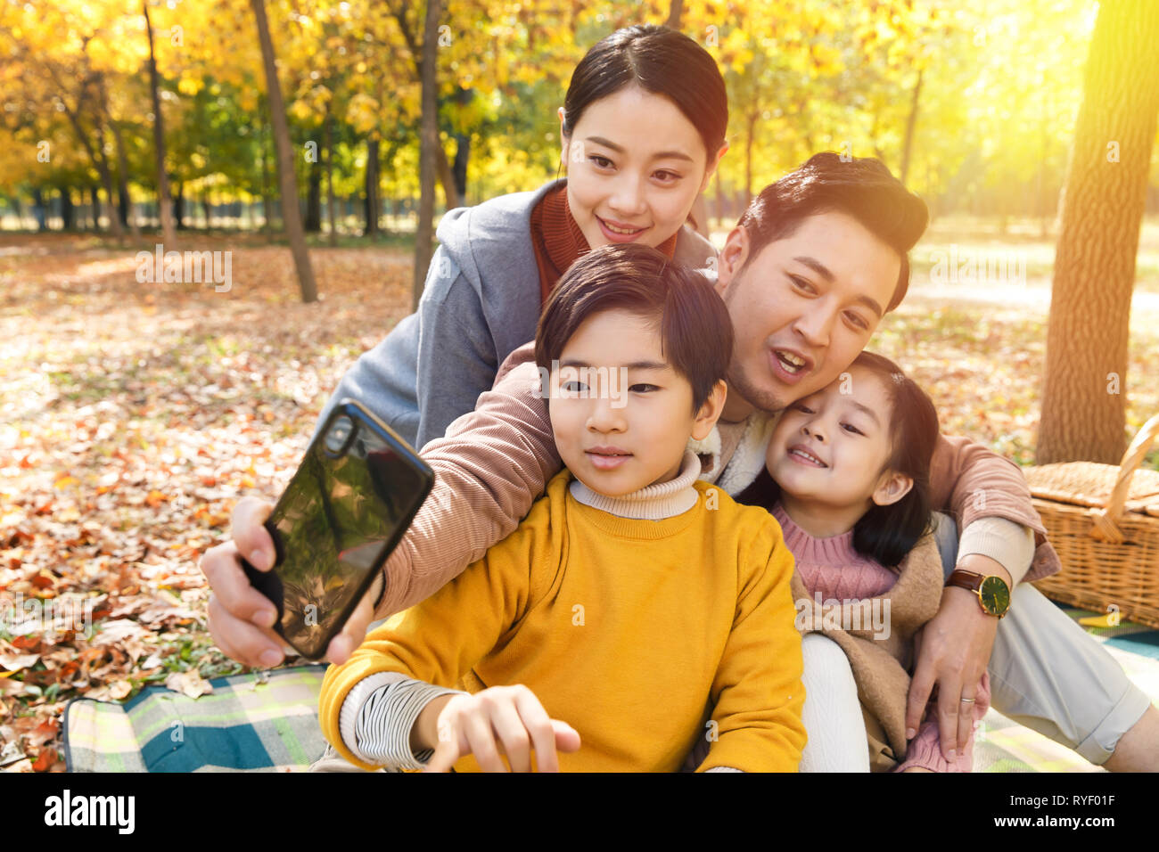 Happy family in the outdoor taking pictures Stock Photo - Alamy
