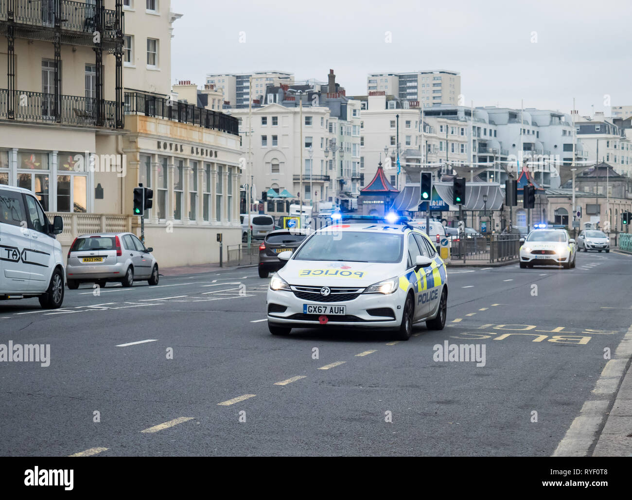 Two Police Vehicles responding to emergency call along King's Road, Brighton seafront. Stock Photo