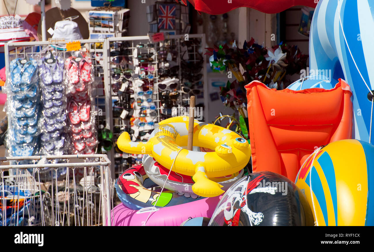 Colourful inflatable toys for sale in a shop in the seaside town of  Brighton, Sussex, England Stock Photo - Alamy