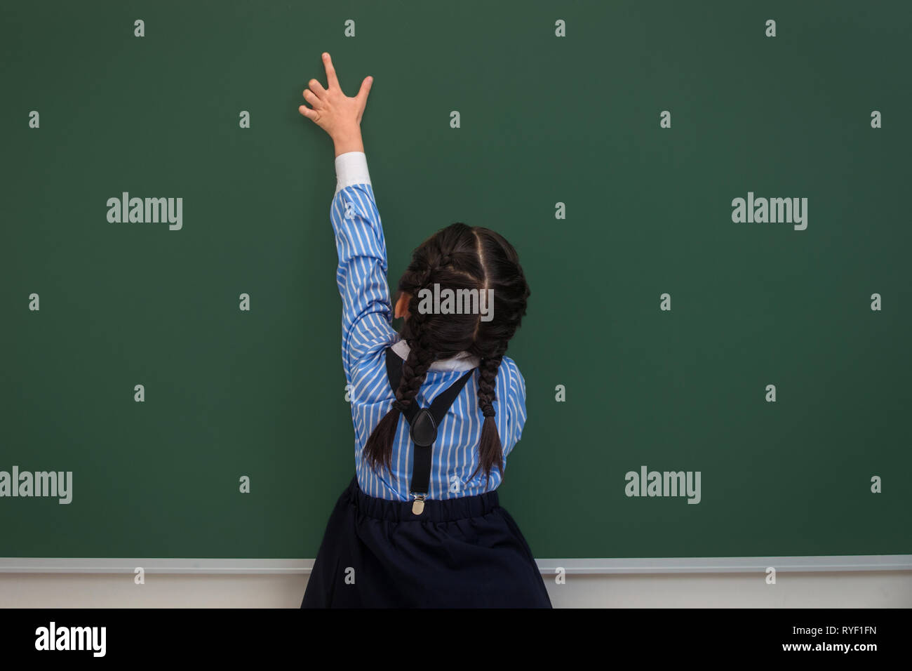 School girl uniform rear view hi-res stock photography and images - Alamy
