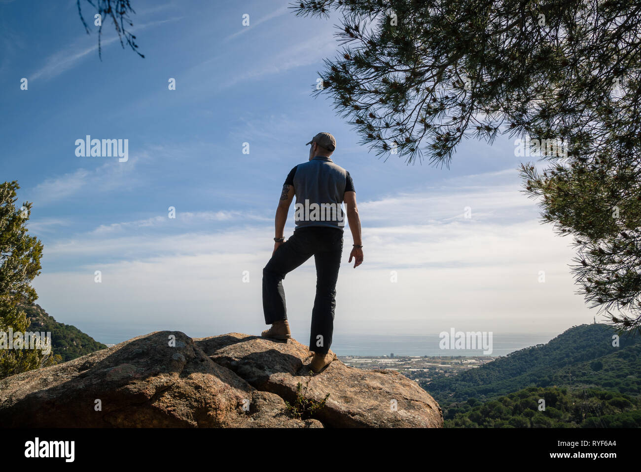 A hiker on the top of a mountain enjoying the great view, back view, concept freedom Stock Photo