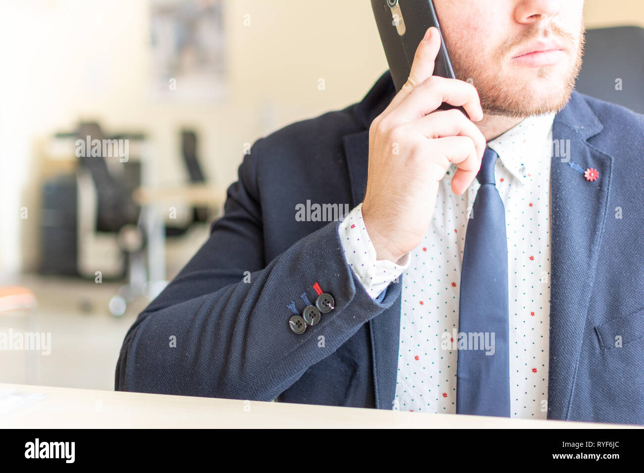 Man sitting while using the mobile smartphone. Confident Entrepreneur working on phone Stock Photo