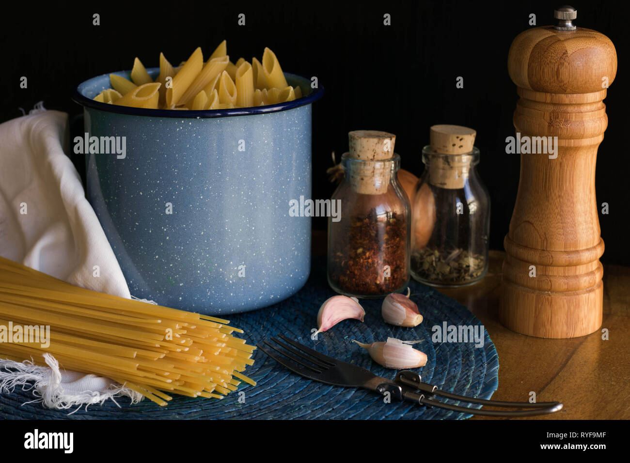 short and long pasta scene, garlic and pepper background Stock Photo