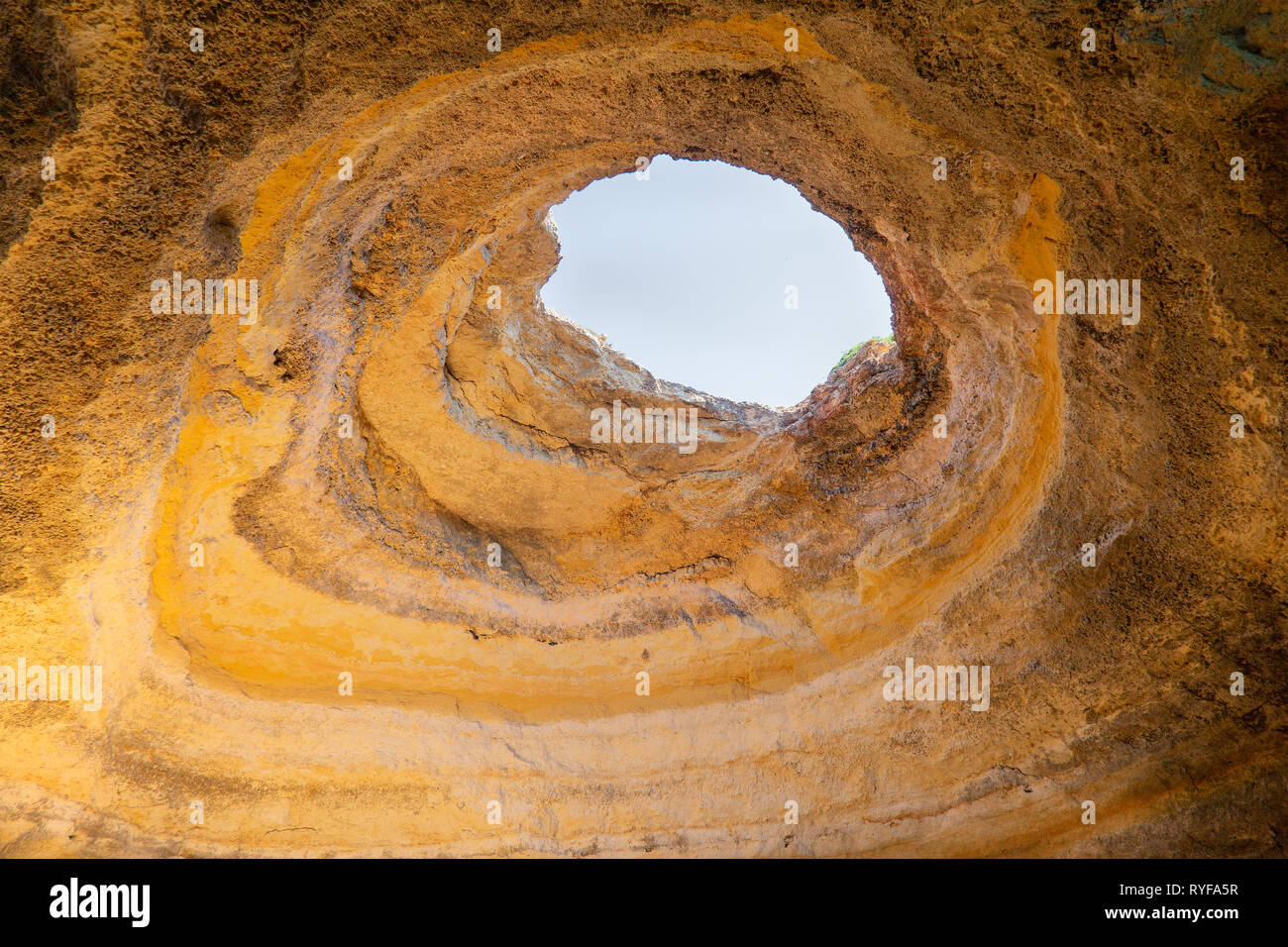 Looking up to a hole in a cave roof near Carvoeiro in Portugal Stock Photo