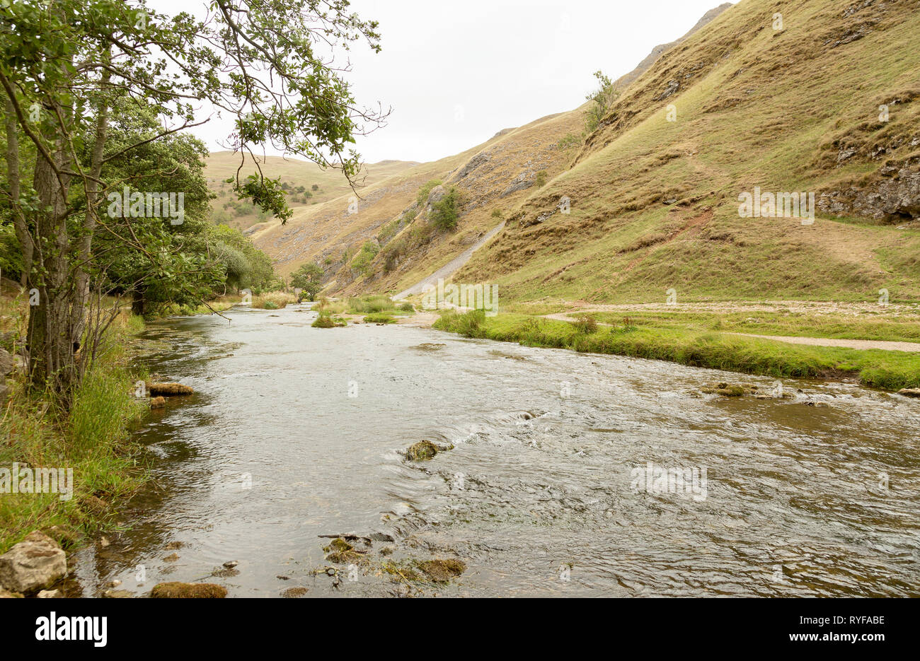 River Dove running through steep hills in Dovedale, Derbyshire UK Stock Photo