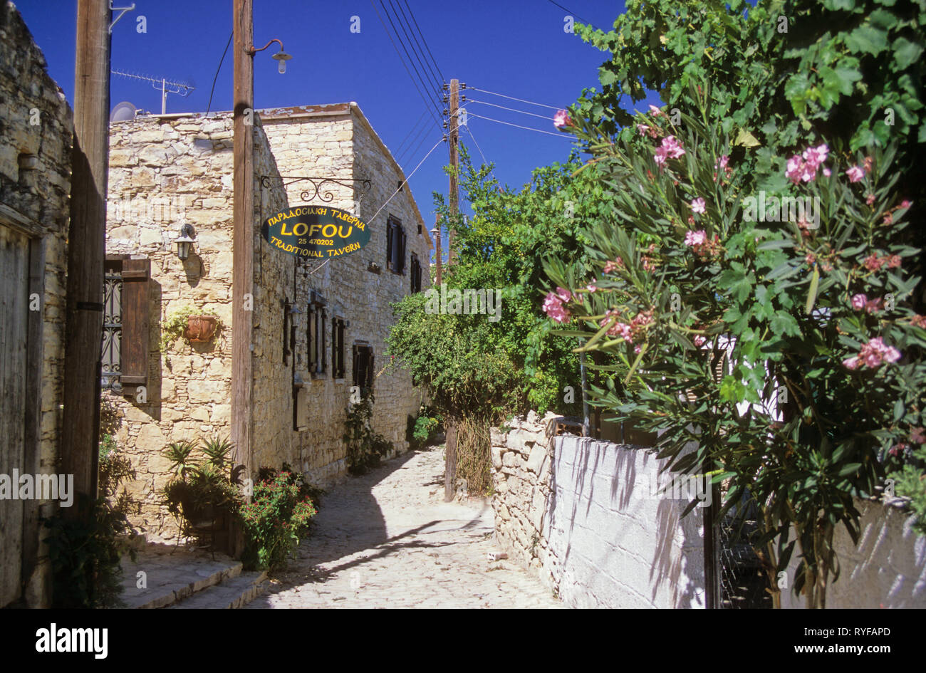 picturesque lane with taverna sign for Kostas Violaris's Iy Lofou restaurant: village of Lofou, Cyprus Stock Photo