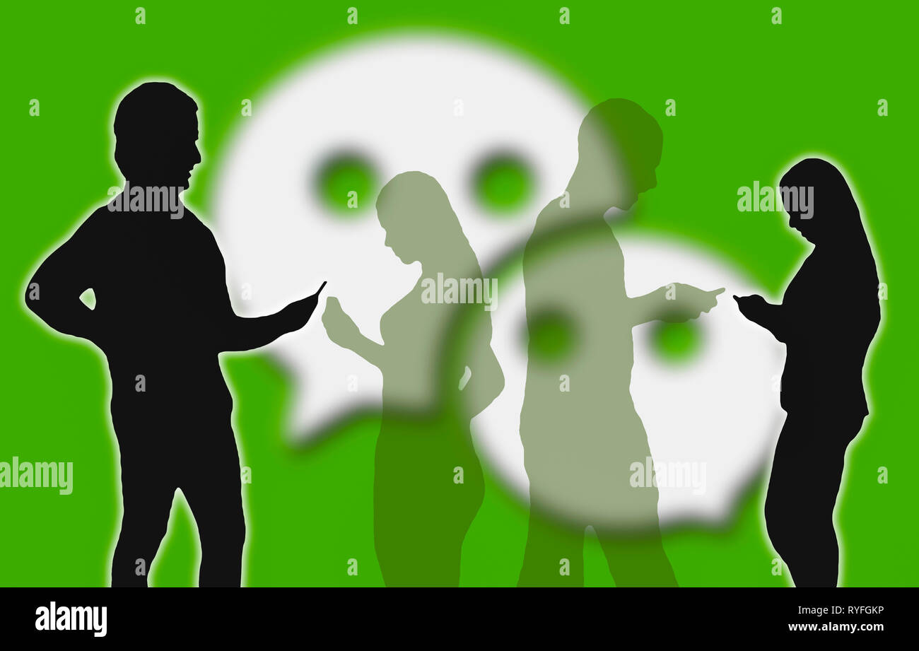 Silhouettes of group of people with mobile devices using the WeChat app. Stock Photo
