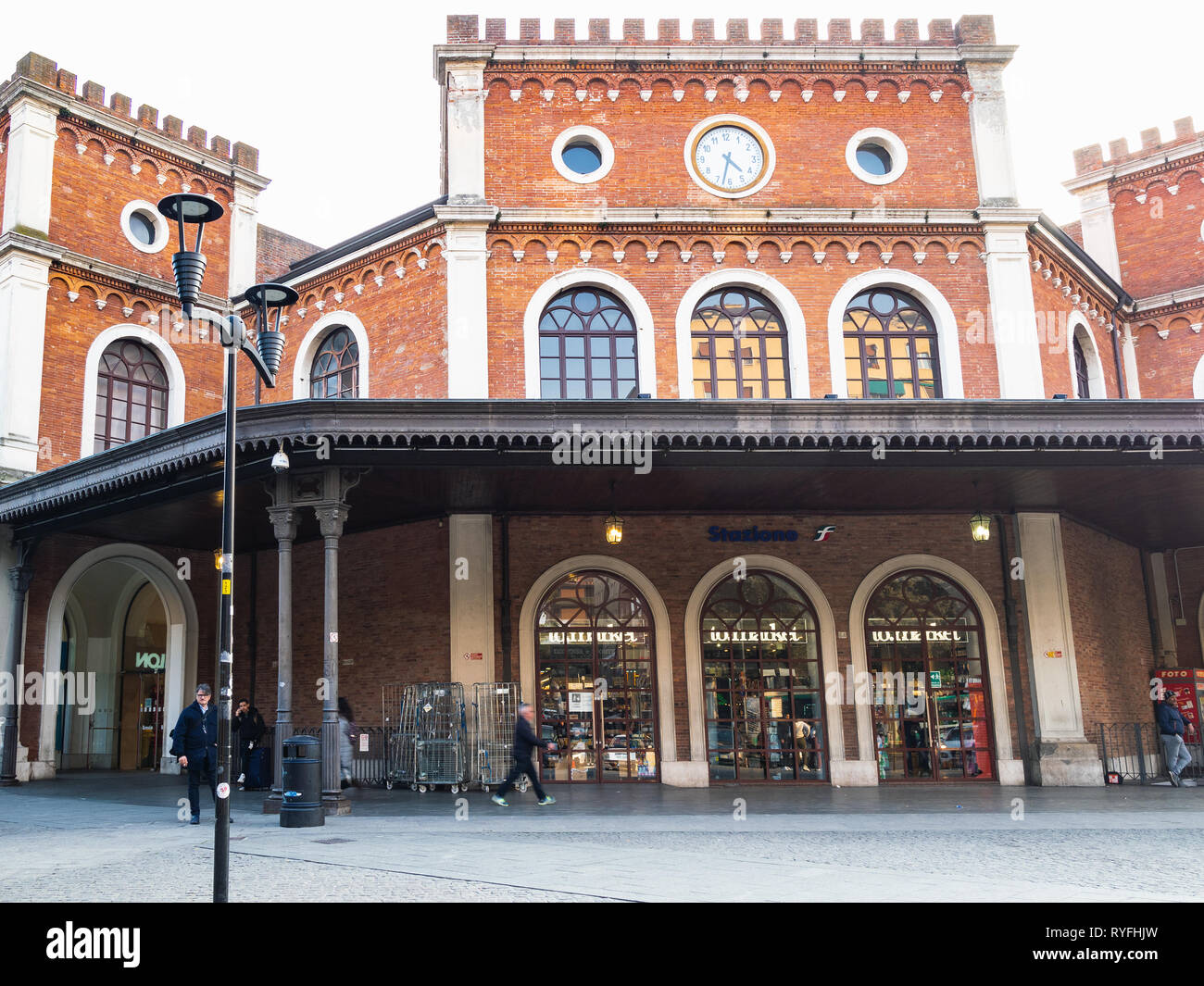 BRESCIA, ITALY - FEBRUARY 21, 2019: people in front of train station in Brescia city in evening. Brescia is the second largest city in Lombardy Stock Photo