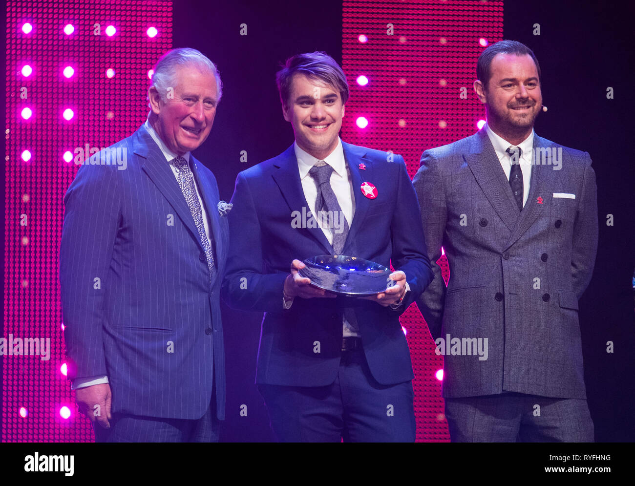 The Prince of Wales with Danny Dyer (right) and winner of Mentor of the Year Award Rahul Mehra onstage at the annual Prince's Trust Awards at the London Palladium. Stock Photo