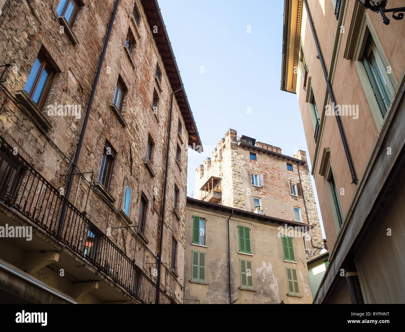 Travel to Italy - medieval apartment houses and view of tower Torre Bruciata in center of Brescia city Stock Photo