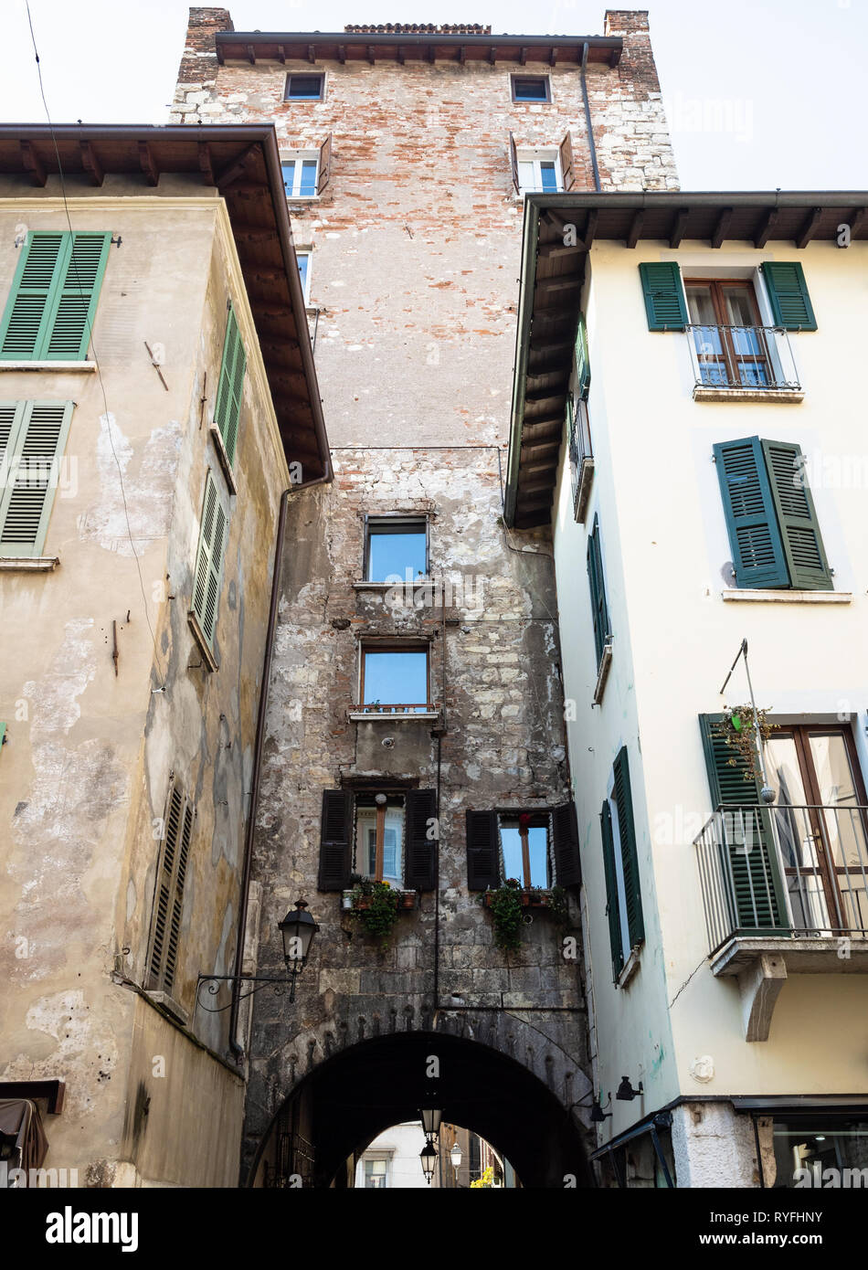 Travel to Italy - medieval apartment houses and tower Torre di Porta Bruciata in Brescia city Stock Photo