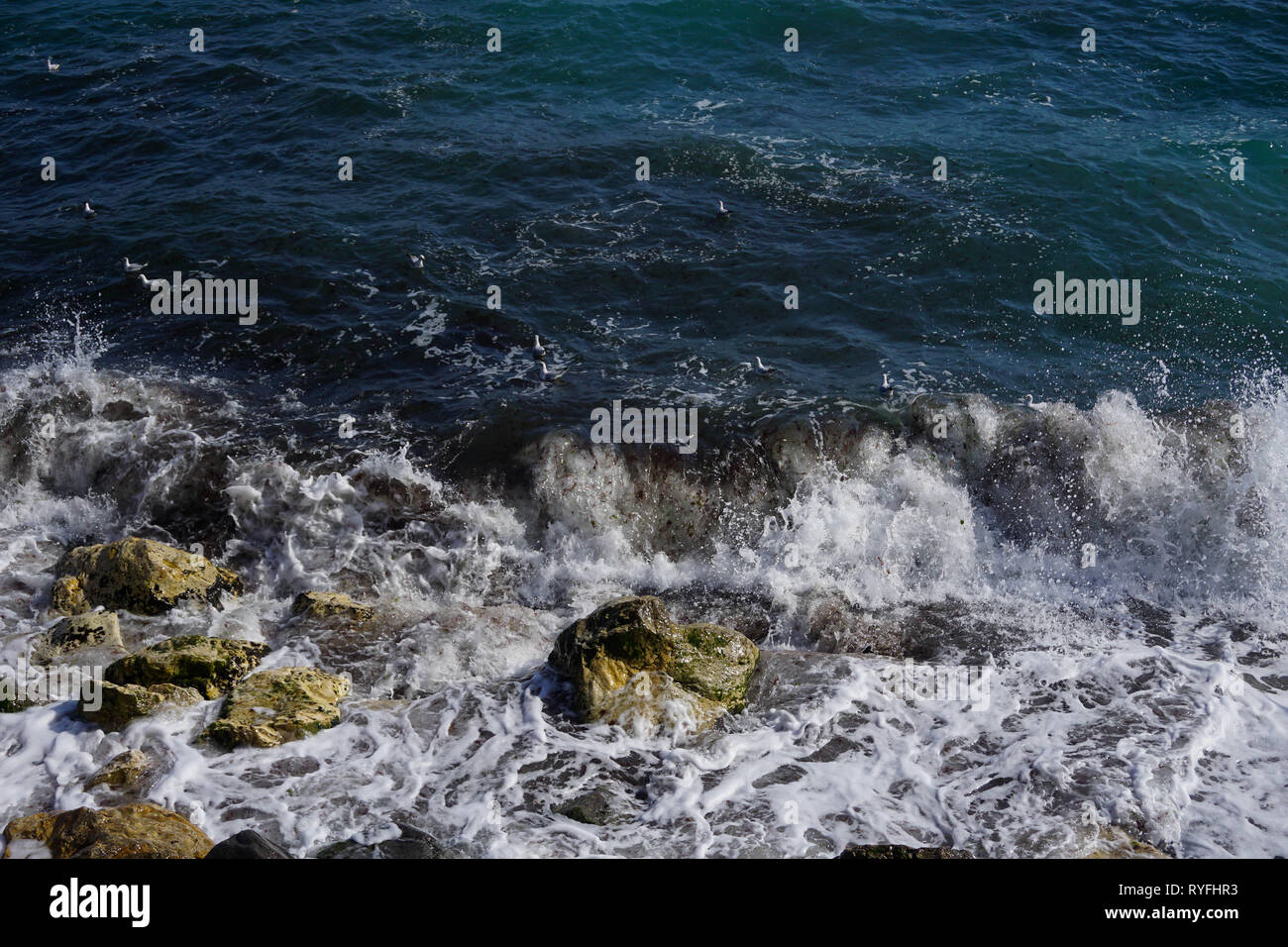 Breaking waves in rocks Stock Photo