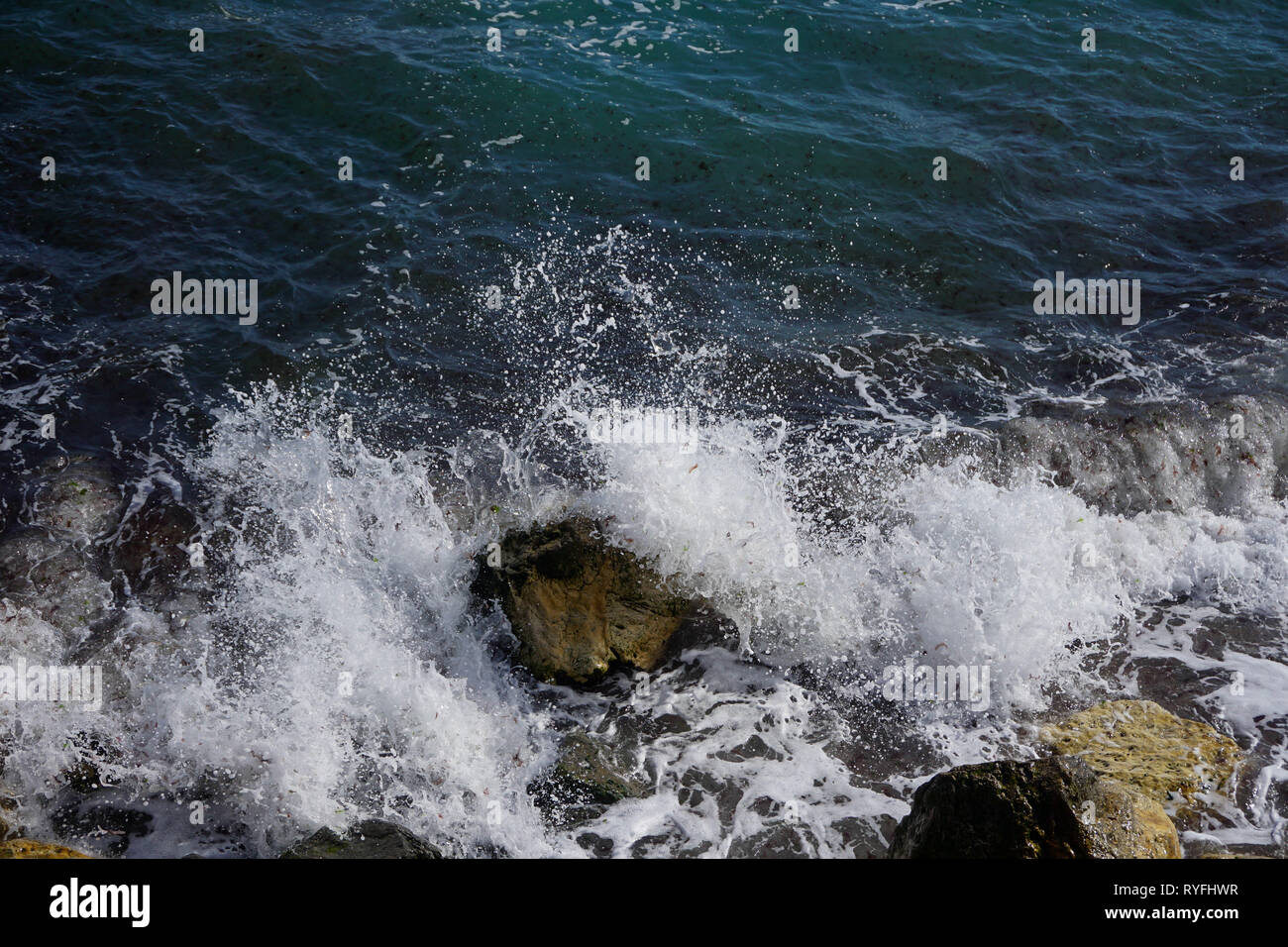 Breaking waves in rocks Stock Photo