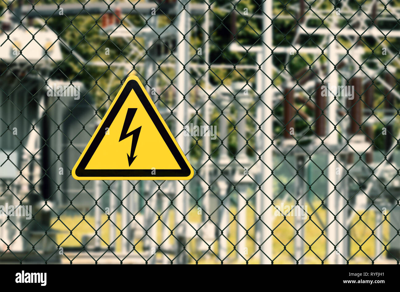 Electrical hazard sign placed on a fence of an electrical substation Stock Photo