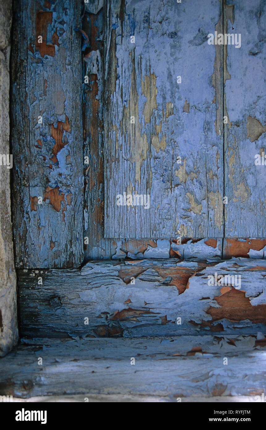 close-up of a weatherbeaten doorpanel in shades of blue, grey and orange Stock Photo