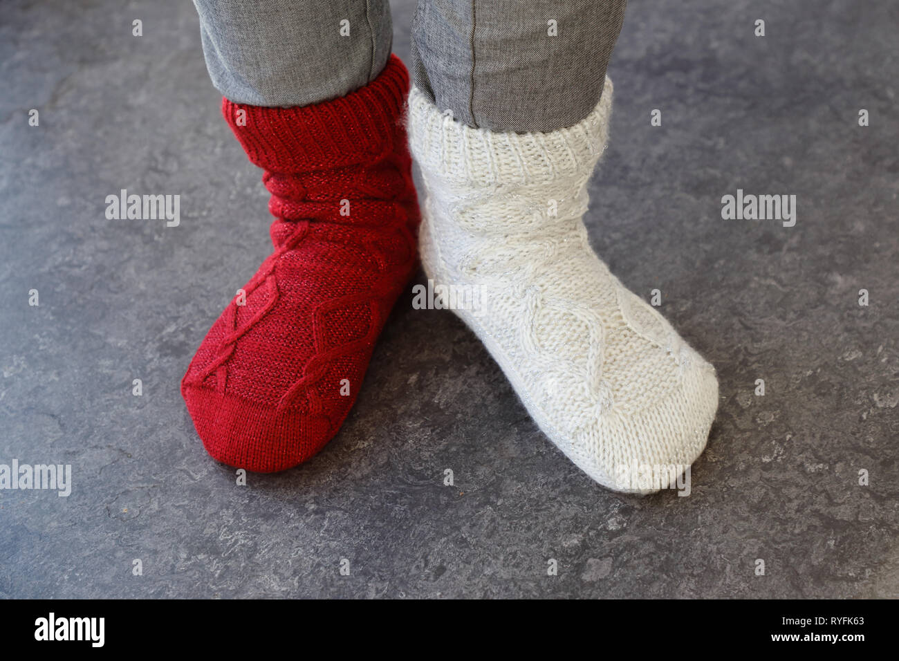 Close up of the feet wearing socks in different color on each foot. Stock Photo
