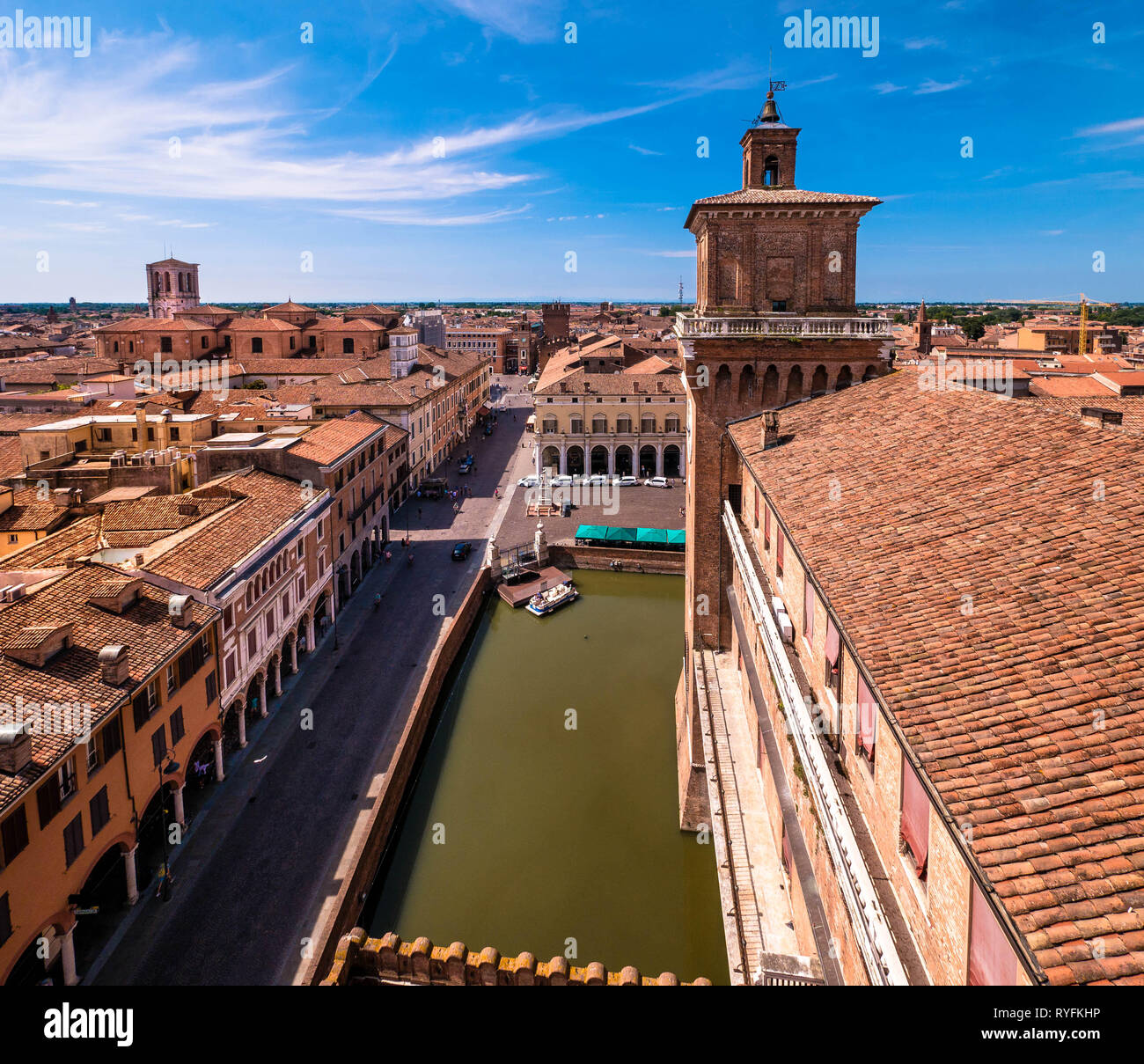 View from the Castello Estense over the green moat towards the Cathedral in Ferrara, Italy Stock Photo