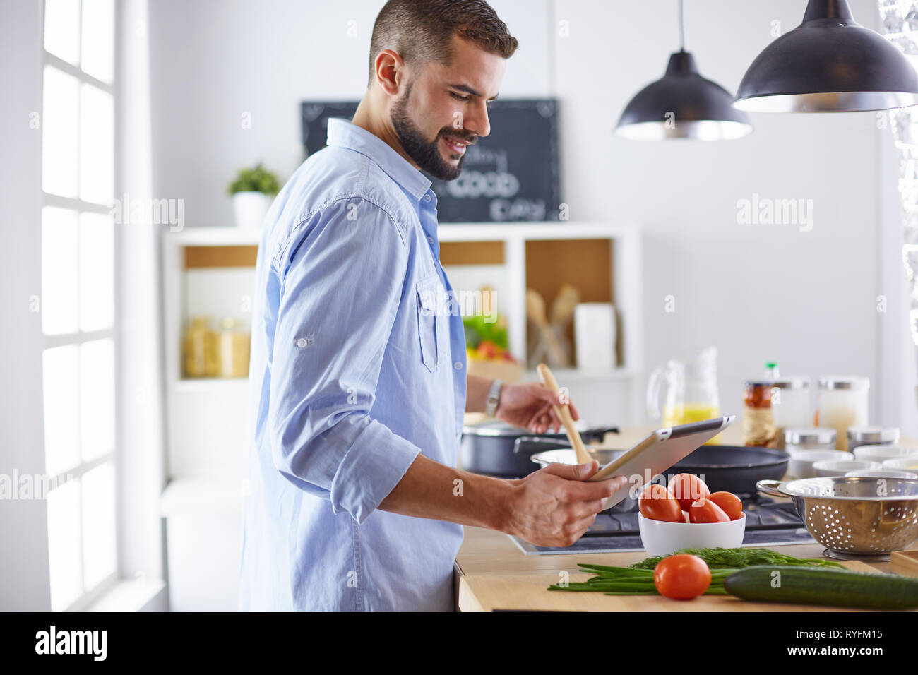 Smiling and confident chef standing in large kitchen Stock Photo