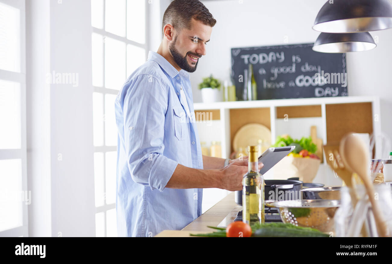 Smiling and confident chef standing in large kitchen Stock Photo