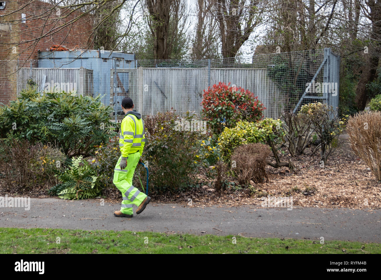 Council gardener wearing Hi-Vis clothing at work in the park Stock Photo