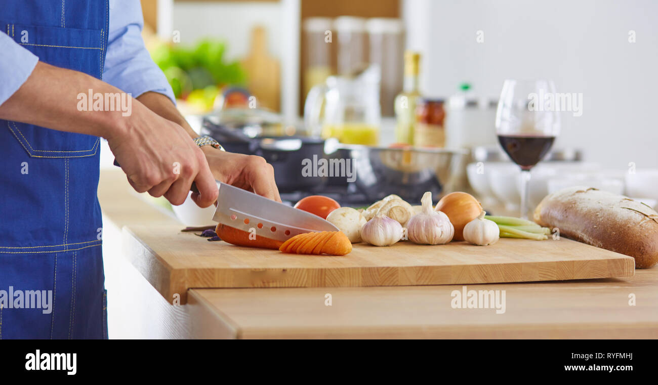 Young chef prepares a man in the kitchen Stock Photo