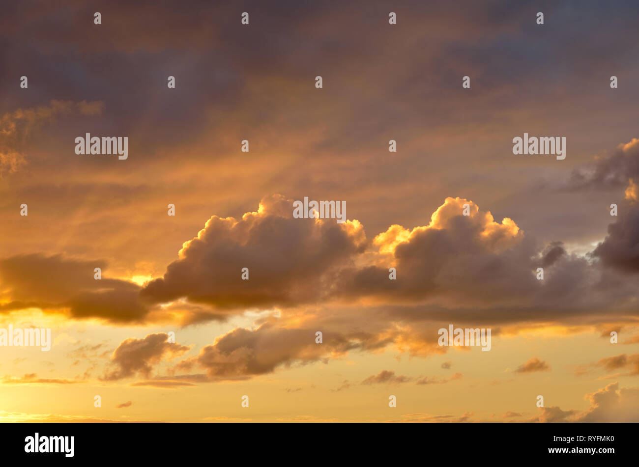 Cloudy sky at sunset,summer evening sky showing rays from setting sun. Stock Photo