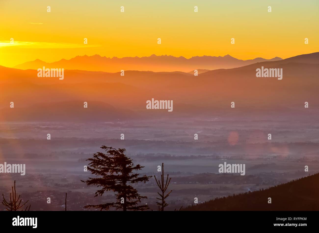 Beautiful morning autumnal mountain landscape. Impressive sunrise over the peaks of the mountains. Stock Photo