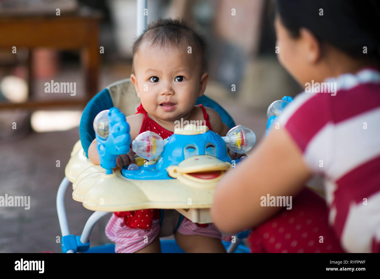 Asian vietnamese baby smiling in his little baby chair, SaPa, Vietnam
