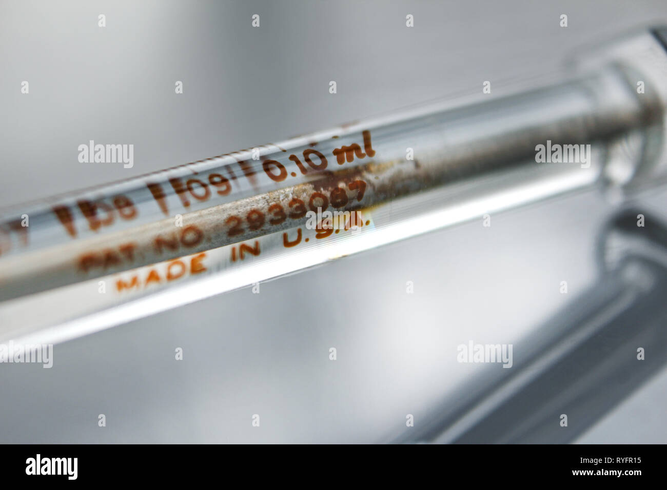 Vintage glass syringe "made in USA", isolated on white background