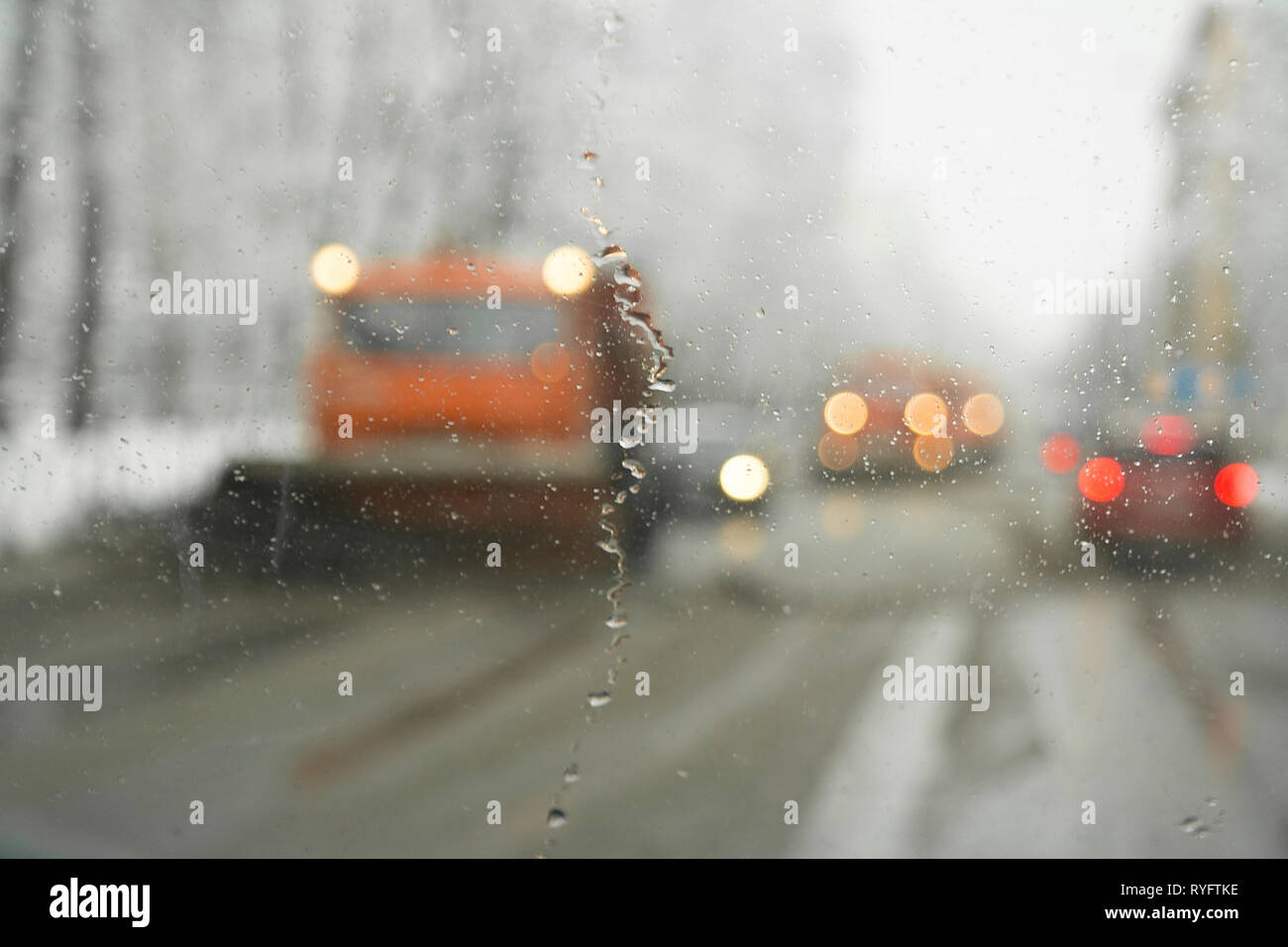 Warning lights of a salt spreader and gritter vehicles, view throgh the