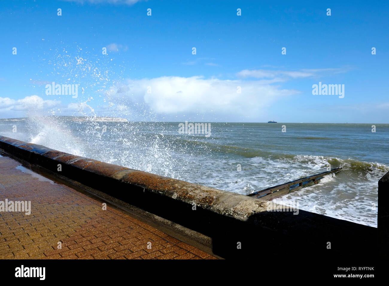 Waves crash against the seafront revetment wall on Shanklin Esplanade seafront, Isle of Wight, UK. Stock Photo