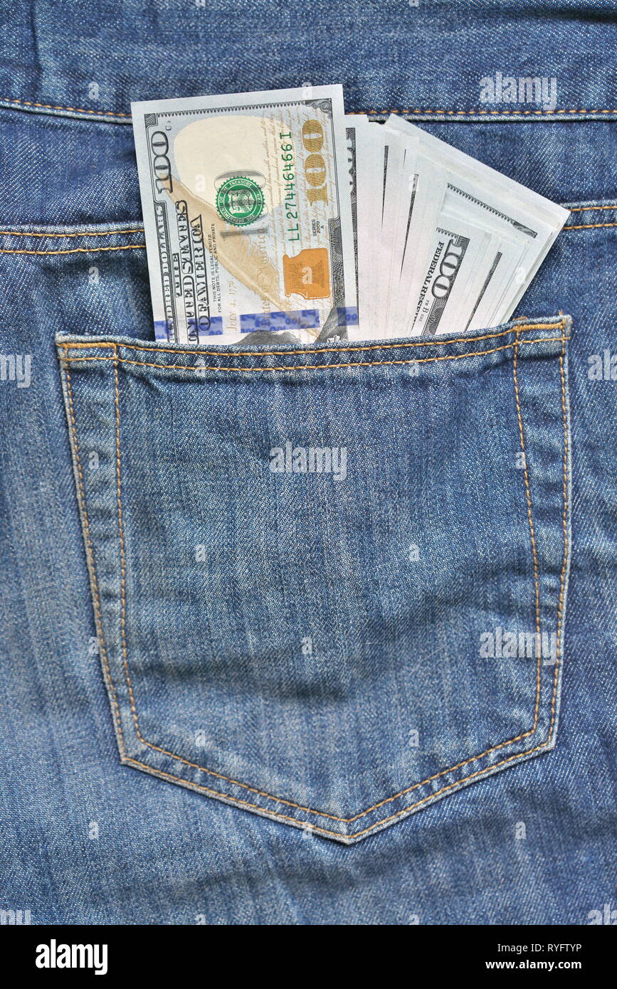Blue jeans with american 100 dollar bill on its pocket Stock Photo