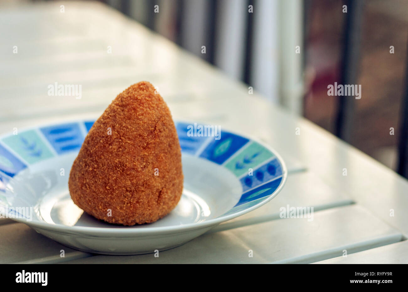 Sicilian snack, fried ball of rice arancino on a plate, tipical street food of Sicily Stock Photo