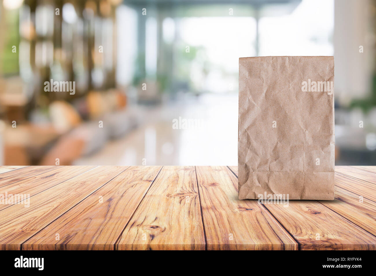 Blank Brown Paper Bag For Taking Away Food On Wood Table Blurred
