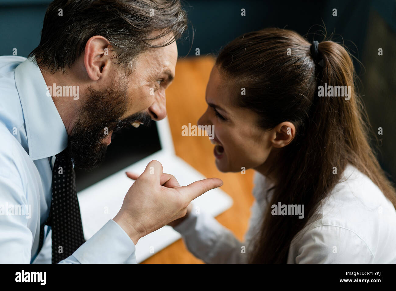 Business colleagues argue and yell at each other Stock Photo