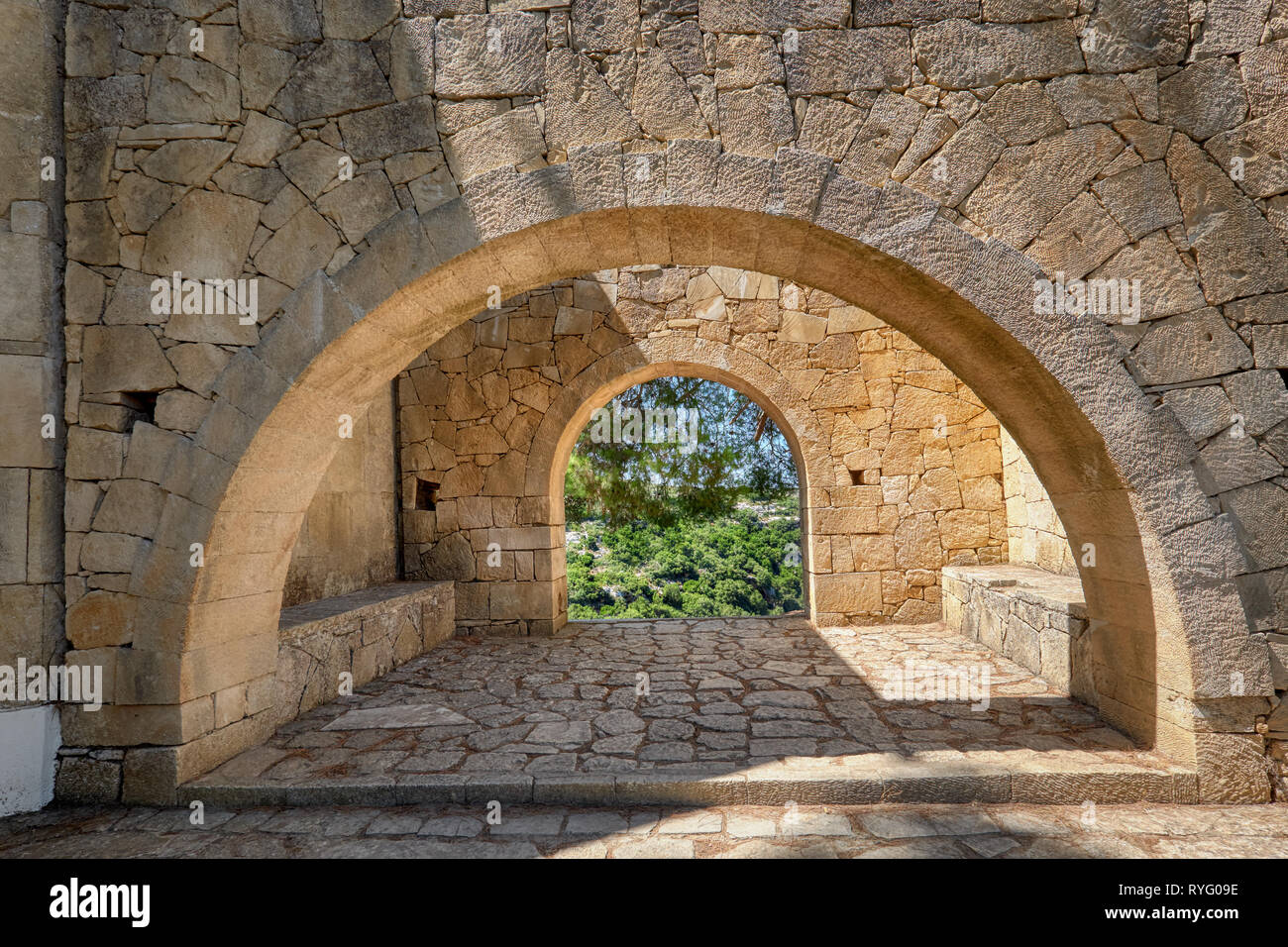 Arcadi monastery in Crete, Greece, stone arches in monastery garden Stock Photo
