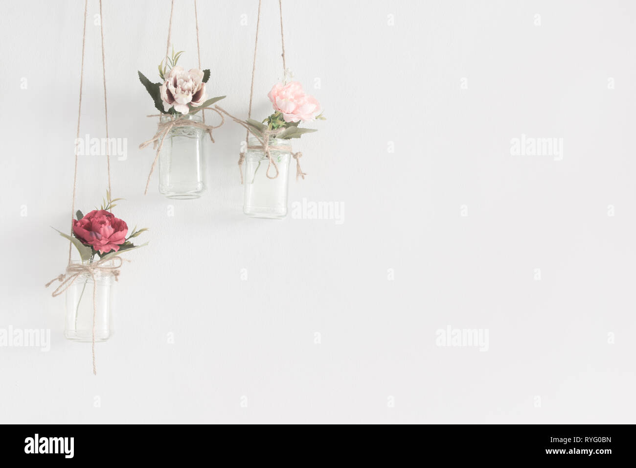 Hanging glass jars with flowers interior wall decoration with copy
