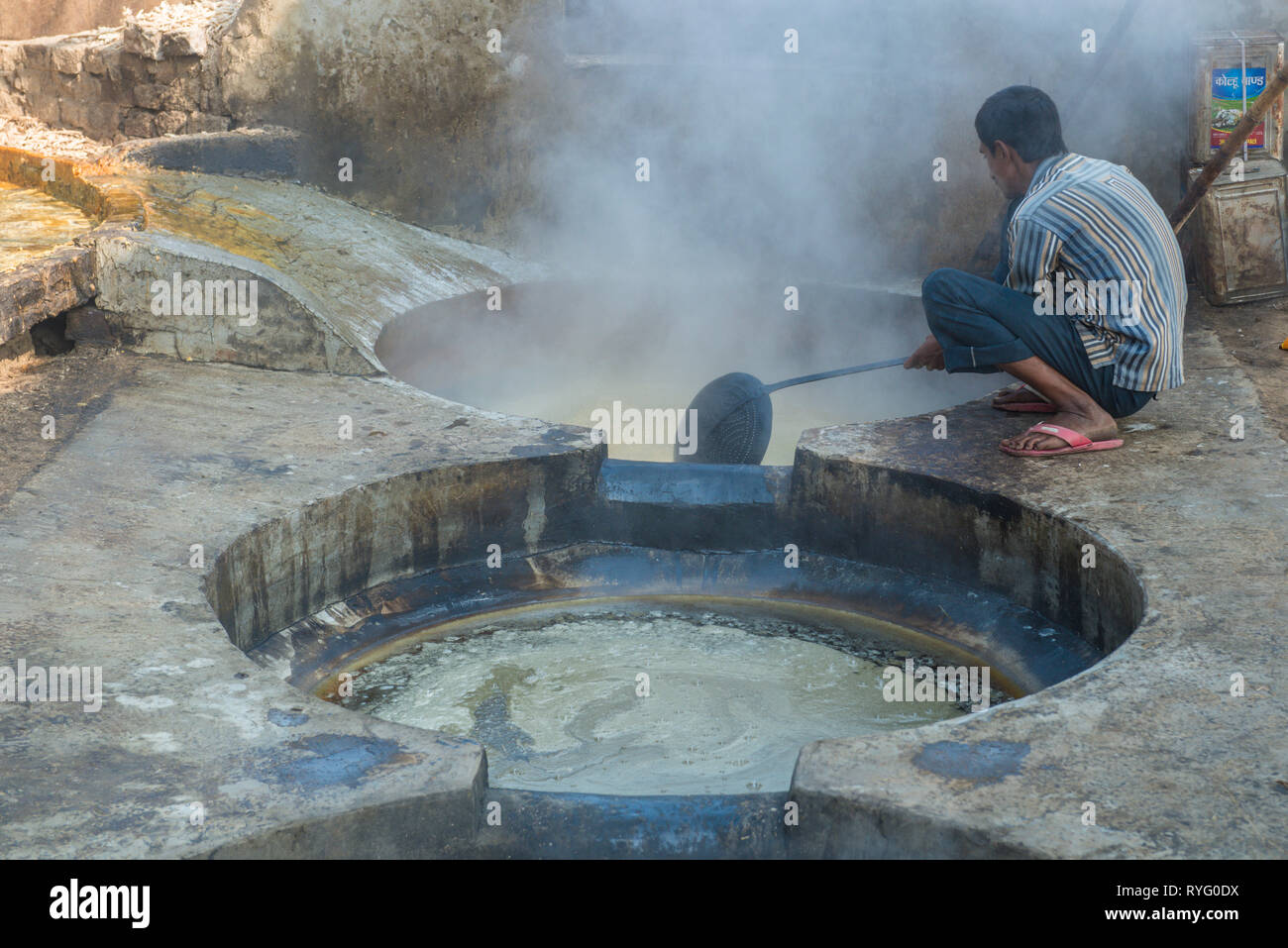 HIMACHAL PRADESH, INDIA. juice of the sugar cane plant is transfomed to crystalline cane sugar by boiling Stock Photo