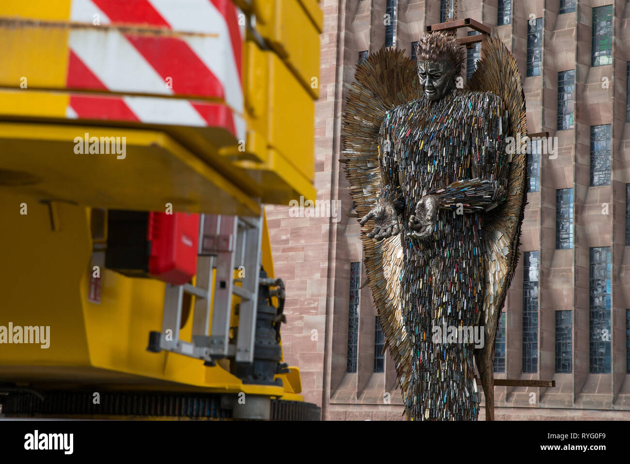 A Knife Angel sculpture, made of 100,000 confiscated knives, is installed at Coventry Cathedral. The 27-foot high artwork, created by artist Alfie Bradley, starts its residence at the cathedral until April 23 'as a physical reminder of the effects of violence and aggression'. Coventry Cathedral, Priory Street, Coventry. Stock Photo