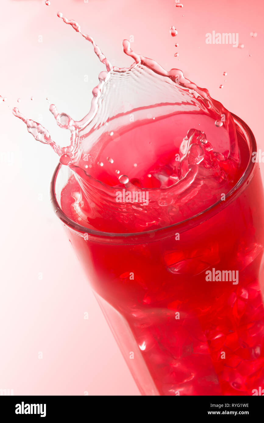 Download Close Up Of A Splash On A Glass Of Strawberry Juice Against A Red Background Stock Photo Alamy PSD Mockup Templates