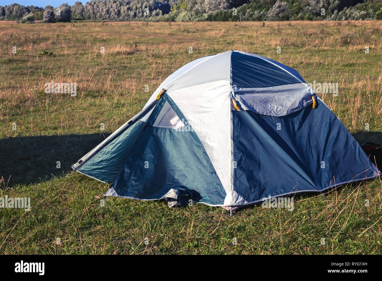 Tourist tent in the meadow in the evening Stock Photo - Alamy