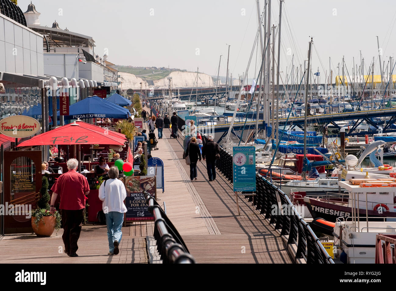 People walking along the boardwalk in Brighton Marina, Sussex, England