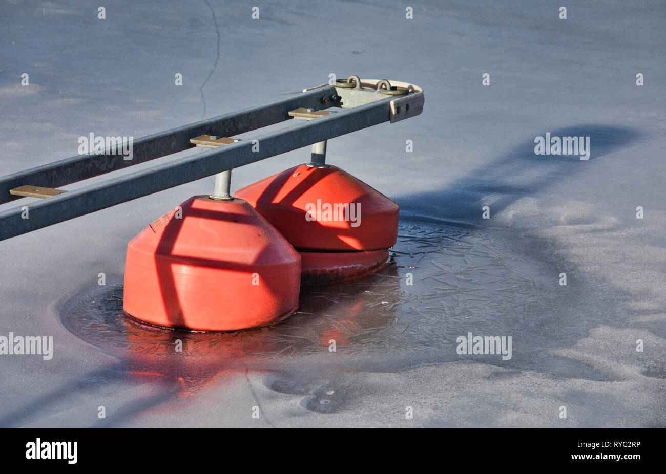 Red buoys floaters frozen in ice of Lake Malaren, Sweden, Scandinavia Stock Photo